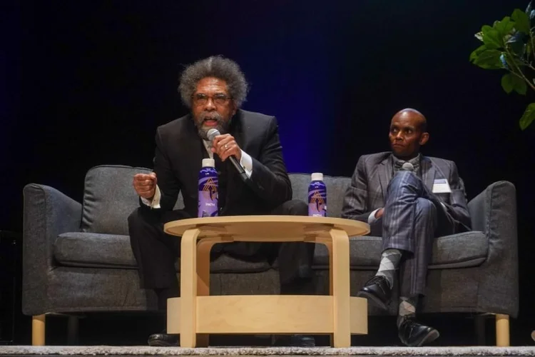 Intellectual lecture and panel discussion with distinguished speakers on stage