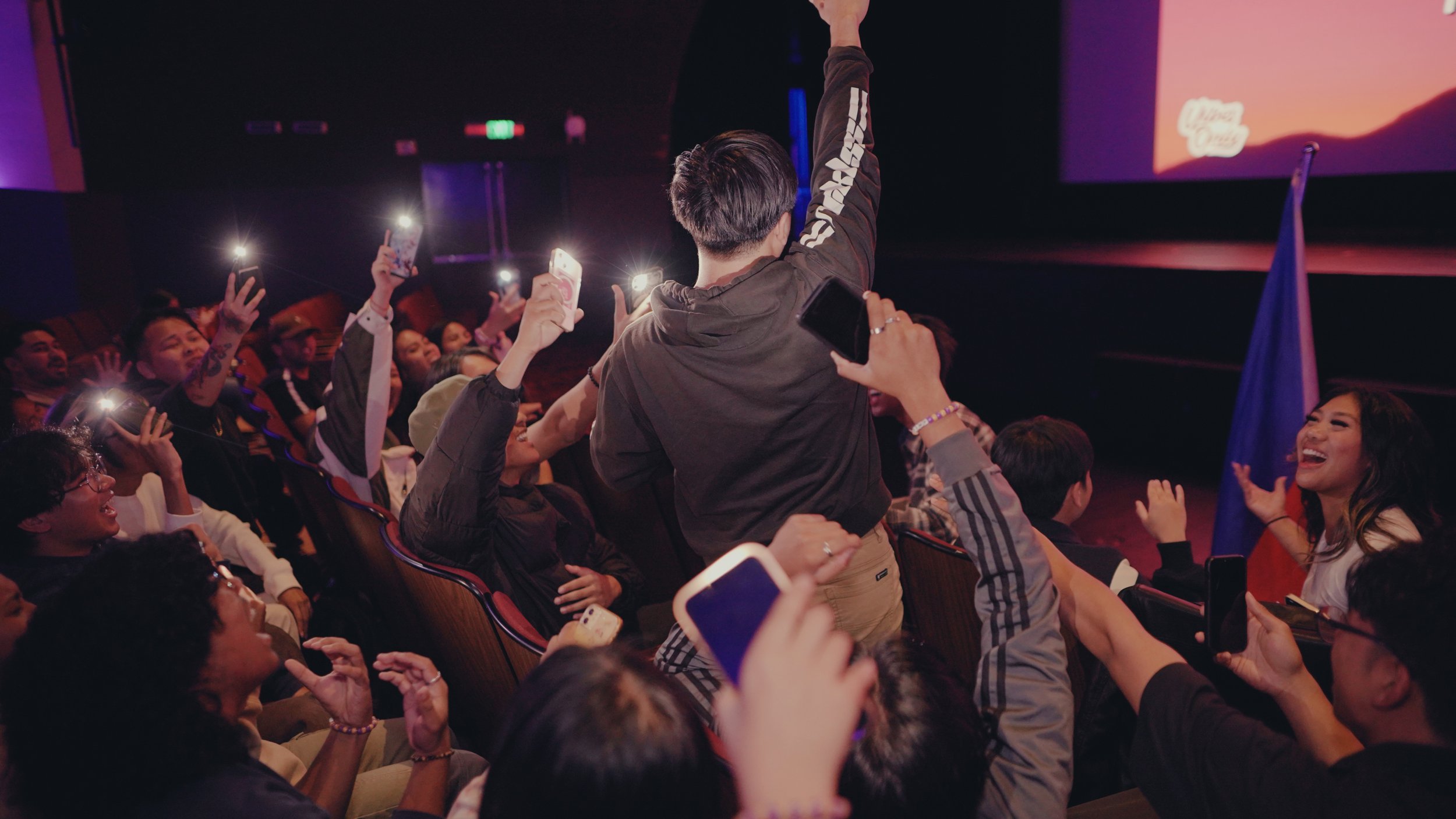 Theatrical performance with dramatic lighting and full audience